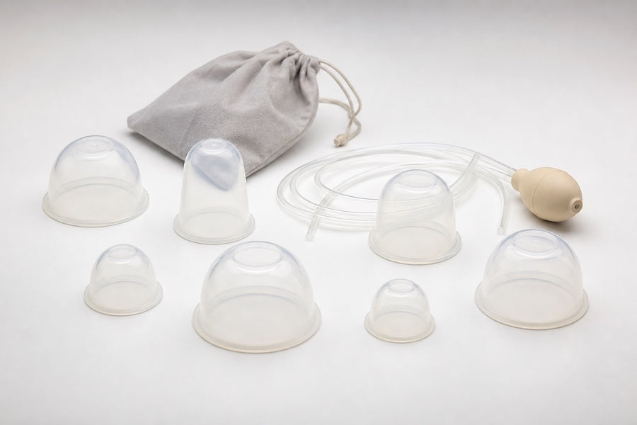 An assortment of generic hand-operated breast pump cups, tubing, and squeeze bulb